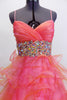 Full length A-line Mac Duggal , coral organza gown, has layers of curly organza ruffles, ruched crossover bust a and a wide Swarovski crystal waistband. Front zoom