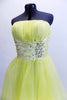 Layers of fluffy, soft yellow tulle with curly edges, form the skirt portion of this knee length dress. The waistband is ruched satin with crystals and sequins. Front zoom