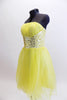 Layers of fluffy, soft yellow tulle with curly edges, form the skirt portion of this knee length dress. The waistband is ruched satin with crystals and sequins. Side