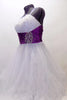 White curly edge tulle boned dress has ruched purple satin waist band with large jewel accents. There is scattered amethyst Swarovski crystals throughout dress. Side