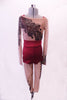 Printed nude mesh full unitard has a black lace pattern in the fabric that cascades at an angle across the torso both front and back. The pattern continues along the long sleeves & legs accented with many scattered crystals. High waisted maroon shorts sit over the unitard and a maroon bra beneath. Front