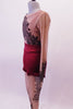 Printed nude mesh full unitard has a black lace pattern in the fabric that cascades at an angle across the torso both front and back. The pattern continues along the long sleeves & legs accented with many scattered crystals. High waisted maroon shorts sit over the unitard and a maroon bra beneath. Side