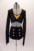 This 2-piece costume has a long-sleeved black lace half top with deep V front and an open back. The lace top sits overtop of a gold sequined bra with pinched front. The high-waisted fully sequined, black, brief style bottom has six gold sequined applique buttons along the left and right hip. Front