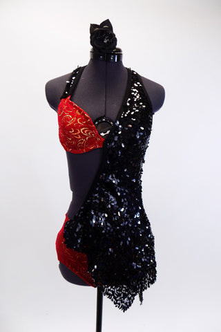 Red velvet halter bra and matching brief has inlaid gold swirl patterns and a black sequin covered shawl-like half-dress that originates from the left shoulder, wrapping around bust to the right hip. The open back has three nude coloured straps to hold the bra in place. (32A). Comes with matching hair accessory. Front
