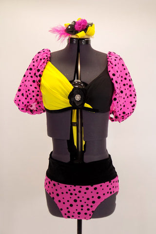 Two piece costume has bright pink pouf sleeves with black spots attached to a yellow and black twist front bra with large yellow back bow & matching pink bottom. Comes with hair accessory. Front
