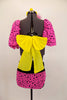 Two piece costume has bright pink pouf sleeves with black spots attached to a yellow and black twist front bra with large yellow back bow & matching pink bottom. Comes with hair accessory. Back