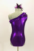 Purple metallic one-shoulder leotard has ruffle accent with crystals. Torso has sequined braiding & large jeweled applique. Comes with feathered hair accessory. Back