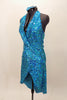 Bright aqua, fully sequined halter dress, has cross-over bodice as well as cross-over skirt with peek-a-boo front.  Comes with applique hair accessory.  Left side