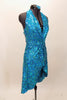 Bright aqua, fully sequined halter dress, has cross-over bodice as well as cross-over skirt with peek-a-boo front.  Comes with applique hair accessory.  Right side