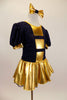 Navy blue crinkle lace dress has pouf sleeves with gold cuffs & gold striped inserts down front center of torso. Has attached gold skirt & matching hair bow. Side