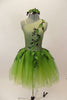 Forest themed green romantic tutu dress has single shoulder with ribbon branches & 3-D leaves.Tutu is layers of soft green fading tulle. Has leaf hair accessory. Front