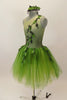 Forest themed green romantic tutu dress has single shoulder with ribbon branches & 3-D leaves.Tutu is layers of soft green fading tulle. Has leaf hair accessory. Left side