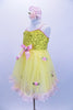 Yellow tutu dress has sequin bodice with satin bow & rose at front. Skirt is layers of yellow tricot with  pale pink satin rosettes. Has matching hair accessory. Left side