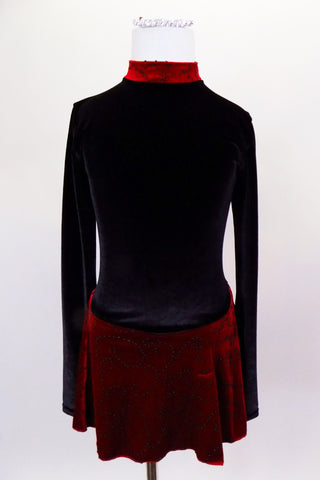 Black velvet skaters dress has long sleeves, high neck with red velvet band and keyhole back. Attached skirt is red with swirls of black beads. Comes with hair accessory. Front