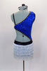 Asymmetrical blue sequined top with black bra is lined with crystals & is connected at the side by a crystal ring. Bottom is an attached white fringed skirt with crystal buckle accent. Has matching hair accessory. Back