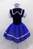 Blue & white sailor themed romantic ballet dress has white pouf sleeves & velvet bodice with lace-up  front. Blue skirt overlay & collar have white ribbon edge over layers of white tulle. Comes with matching sailor hat. Back