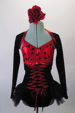 Gorgeous leotard with corset lace up front and open back had red and black polka dot bust and black sequined bottom with layered bustle skirt. The black sequined mini shrug with matching red piping sits on shoulders just above the bra leaving the lower back exposed. Front