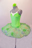 Delicate pale apple green tutu has a white pleated six-layer platter with the attached bodice and overlay. The sparkly green faux sweetheart cut is lined with crystals over a white camisole-style bodice. The sheer sequined lace overlay creates a really pretty soft look. Comes with a green floral hair accessory. Side