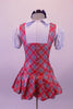 Red white and navy tartan school girl pinafore style costume has an attached pleated skirt and faux white blouse with pouffe sleeves and attached panty. Comes with large navy hair bow. Back