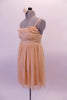 Nude-ivory soft mesh Empire-waist dress has a delicate double ruffle along the scoop bustline. The dress has and a smocked back and thicker straps. The front waistband turns into delicate straps that tie into a bow at the back. Comes with a hair accessory. (dancer needs to provide own brief/short). Side