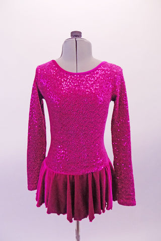 Pretty velvet based long sleeved round neck skating dress is a beautiful fuchsia colour. The skirt is a soft velvet that falls and flows nicely. The back is unique with triple cross-over straps that extend from the shoulders in an angle across the back. Front