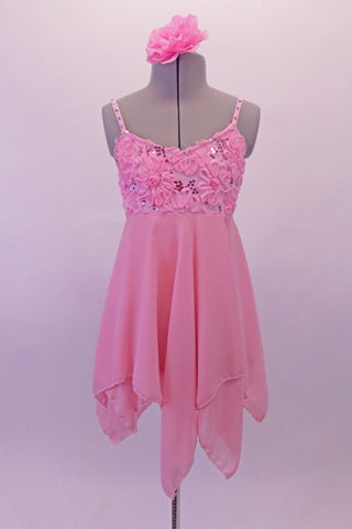 Pale pink dress has empire waist, kerchief bottom and a rose lace bust with sequins and crystal covered straps. The varied length of the skirt gives the costume a lovely flowy feel. Comes with a floral hair accessory. Front