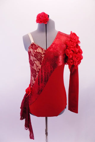 Red leotard has a single long sleeve with rose lace ruffled shoulder. The entire leotard is divided into angled sections. The top is a nude base with red French lace overlay. The section below is a shiny marble like stripe along the front, while the bottom section is a matte red. Right hip has red lace kerchief & rose. Front