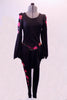 Jerry’s skate costume great for warm-up is black leggings with a colourful floral stripe down the legs. The matching dress style tunic top has pouffe upper sleeve and peplum style ruffle. The bright floral pattern in the shoulders and sleeves complement the stripe in the leggings and the waistband of the tunic. Front