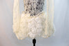 Custom, ivory lace long sleeved dress has open back lined with thick beaded bridal appliqué. Skirt is layers of tulle and silk rose fabric. covered crystals.Front lower zoom