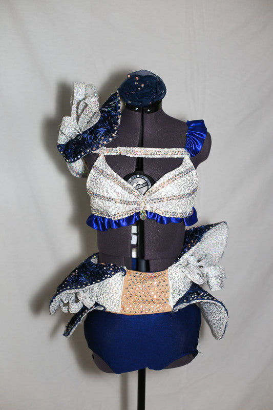 Double layered blue/silver wave skirt, hugs the hips/waist, by Velcro band.Bra has blue satin ruffles,covered with AB crystals and shoulder piece mimics skirt, front