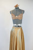 Gold shiny spandex brief, gold sequined bra and long flowing, ankle length, gold wrap skirt.skirt. with a gold hairpiece, front