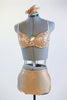 Gold shiny spandex brief, gold sequined bra with a gold hairpiece, no skirt