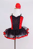 Red sequin leotard  has center panel of black ruffles. Comes with black  tulle skirt with red satin edge, black gauntlets & red satin floral hair accessory. Front