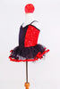 Red sequin leotard  has center panel of black ruffles. Comes with black  tulle skirt with red satin edge, black gauntlets & red satin floral hair accessory. Side
