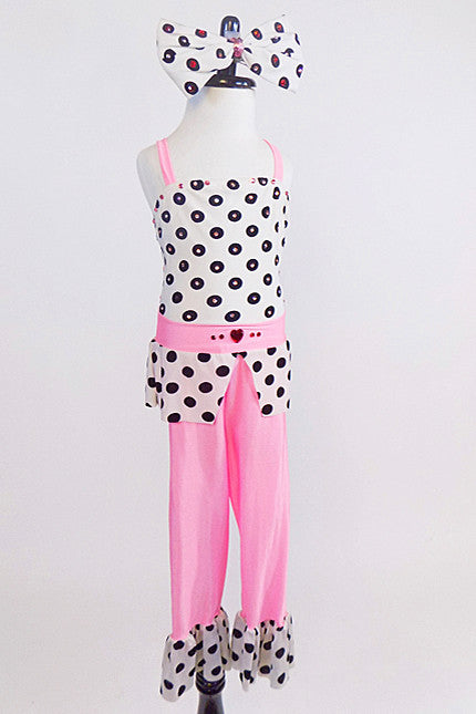 Pink capri pant with black& white polk-a-dot ruffle, matching polk-a-dot crystalled top with peplum & pink waistband.  Has large matching bow hair piece.  Front