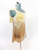 Cream satin baby-doll dress with attached panty. The bodice is s covered with a gold sequined lace with soft  bow & flower accent on the right shoulder. Side Right