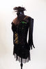 Black merry-widow style mesh dress has lace up corset front with green lace accent. Costume is covered with  crystals & has long black gloves & head piece. Side