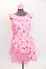 Pink leotard dress has pink sequined, floral lace overlay & high-low skirt . The scoop neck and low  back are has pink crepe ruffle.& matching hair accessory. Front