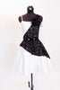 White dress has sateen skirt with black lace overlay & waistband adorned with crystal & black beaded appliques. Comes with long black gloves & hair accessory. Front