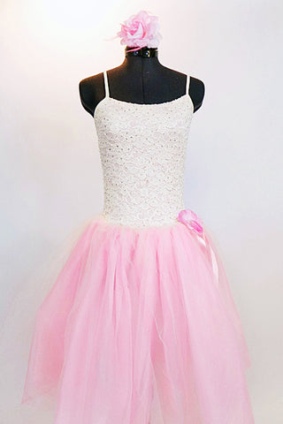 Soft pink nylon and tulle romantic ballet tutu dress has bodice with glitter cream lace and rose floral hair accessory. Front