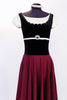 Ballet character dress has cream cap-sleeved & black velvet vest with crystals. Waist has a Swarovski broach & skirt is burgundy stretch with black satin trim. Front zoom