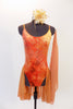 Burnt orange camisole leotard has a tie-dye effect with gold leaf pattering, scalloped low back with straps & an attached chiffon skirt. Has hair piece & scarf. Front
