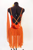 Burnt orange camisole leotard has a tie-dye effect with gold leaf pattering, scalloped low back with straps & an attached chiffon skirt. Has hair piece & scarf. Back