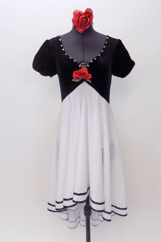 Black velvet bodice is attached to a chiffon  high low skirt with black satin edging.Costume has crystal accents & a single red rose. Has red rose hair piece. Front