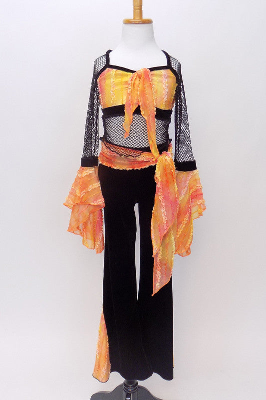 Orange tie-dye bodice with straps & edging has torso & long sleeves of loose black mesh, with  orange sleeve ruffles & black velvet pants with ruffled inserts. Front