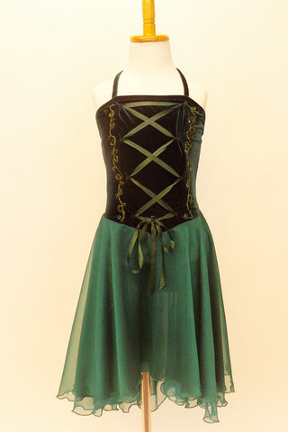 Dark green dress has velvet bodice with corset style lacing, painted designs and green crystal accents. The skirt is comprised of layers of flowing chiffon. Front
