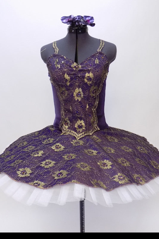 Classical tutu with white base and dark purple velvet and gold lace overlay. Bodice has lace straps and front lace center panel adorned with crystals. Front