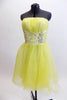 Layers of fluffy, soft yellow tulle with curly edges, form the skirt portion of this knee length dress. The waistband is ruched satin with crystals and sequins. Front