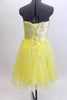 Layers of fluffy, soft yellow tulle with curly edges, form the skirt portion of this knee length dress. The waistband is ruched satin with crystals and sequins. Back