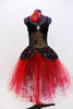 Black sequined, lace bodice accents romantic ballet tutu dress with crystal broach accent. Skirt is layers of black and red tulle.Has red floral hair accessory. Front